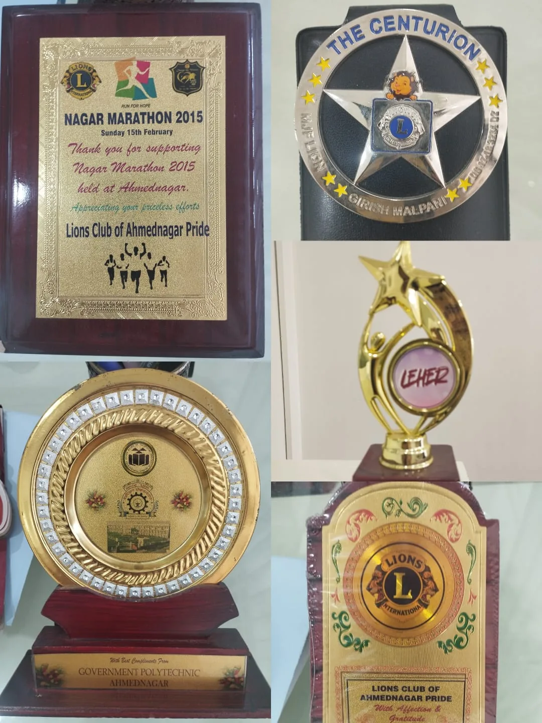 Recognition plaques from Lions Club of Ahmednagar Pride and community organisations